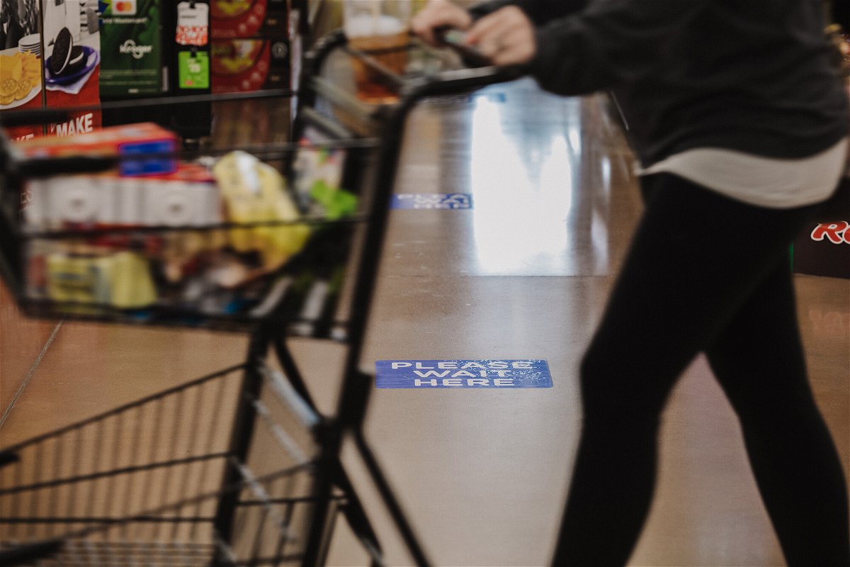 <i>Scotty Perry/Bloomberg/Getty Images</i><br/>Kroger said on Friday a press release touting the acceptance of bitcoin cash at its stores this holiday season is fraudulent. A shopper walks past a social distancing marker at Kroger Marketplace in Versailles