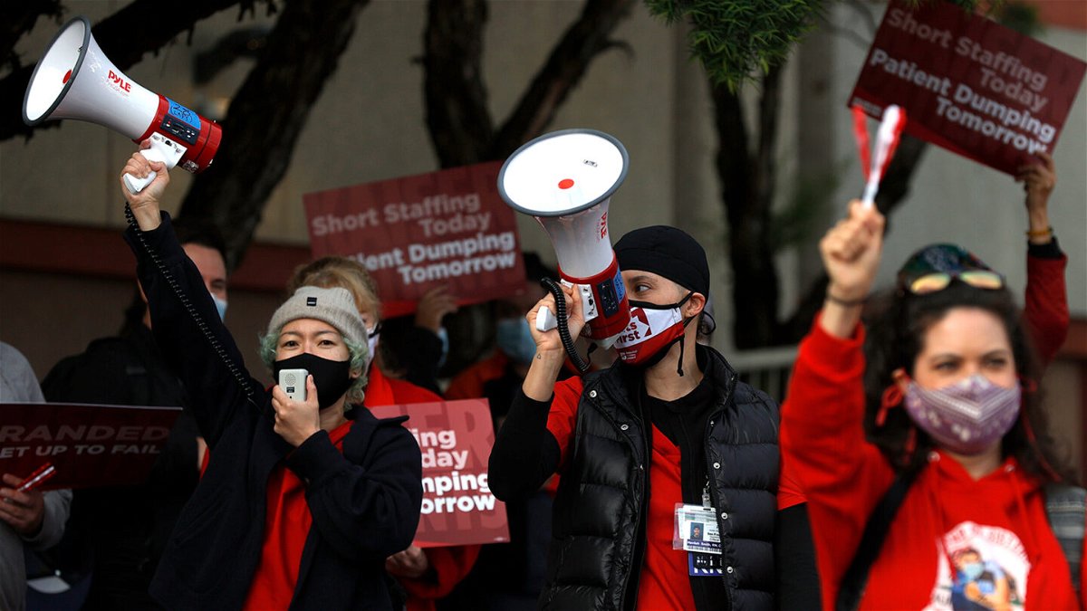 <i>Justin Sullivan/Getty Images</i><br/>Kaiser Permanente nurses hold signs and use bullhorns during an informational picket outside of the Kaiser Permanente San Francisco Medical Center on November 10.