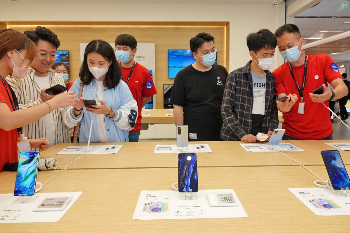 <i>Tang Ke/Costfoto/Barcroft Media/Getty Images</i><br/>Xiaomi stumbled in the third quarter as it grappled with fallout from the global chip shortage and fiercer competition. Customers are shown here buying phones at a Xiaomi store in Yantai