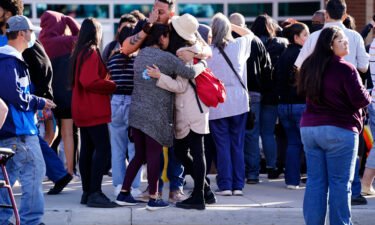 Parents reunite with their children outside of Hinkley High School in Aurora