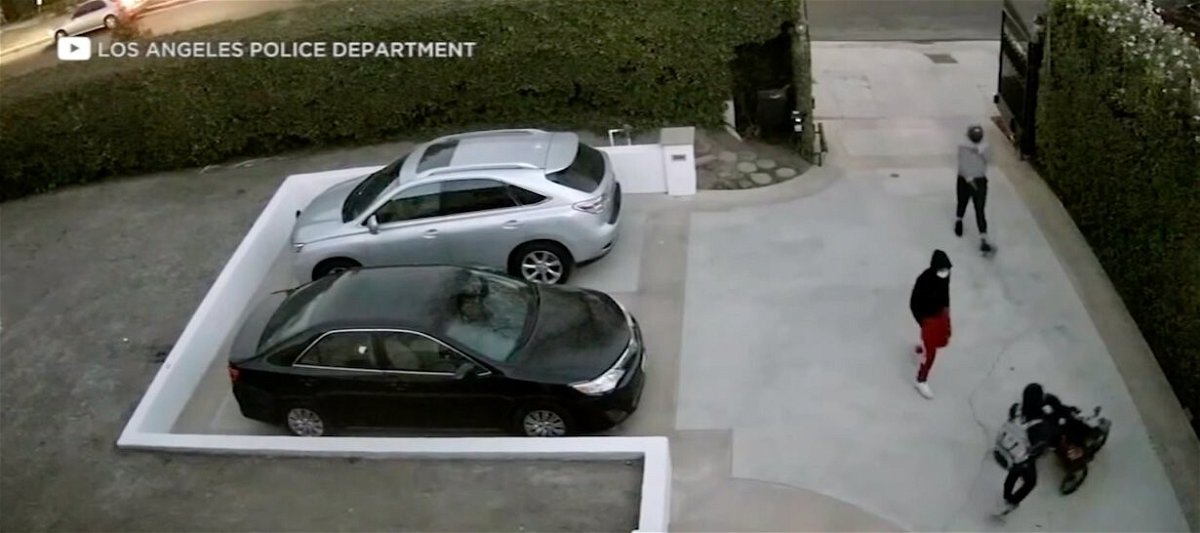 <i>LAPD/KABC</i><br/>Los Angeles police released surveillance video of the moment two men cornered and robbed a woman who was with her baby in the driveway of their Los Angeles home.