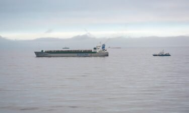 The Scot Carrier (left) and the capsized cargo ship Karin Hoej (center