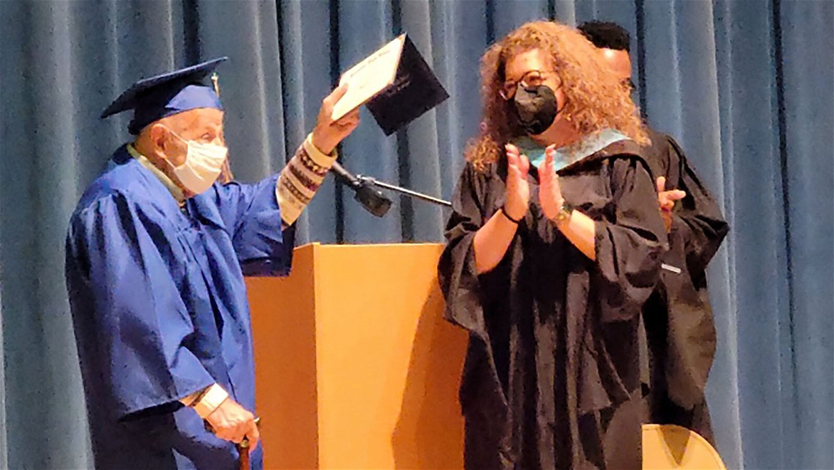 Ernie Reda receives his high school diploma from Stadium High School's principal