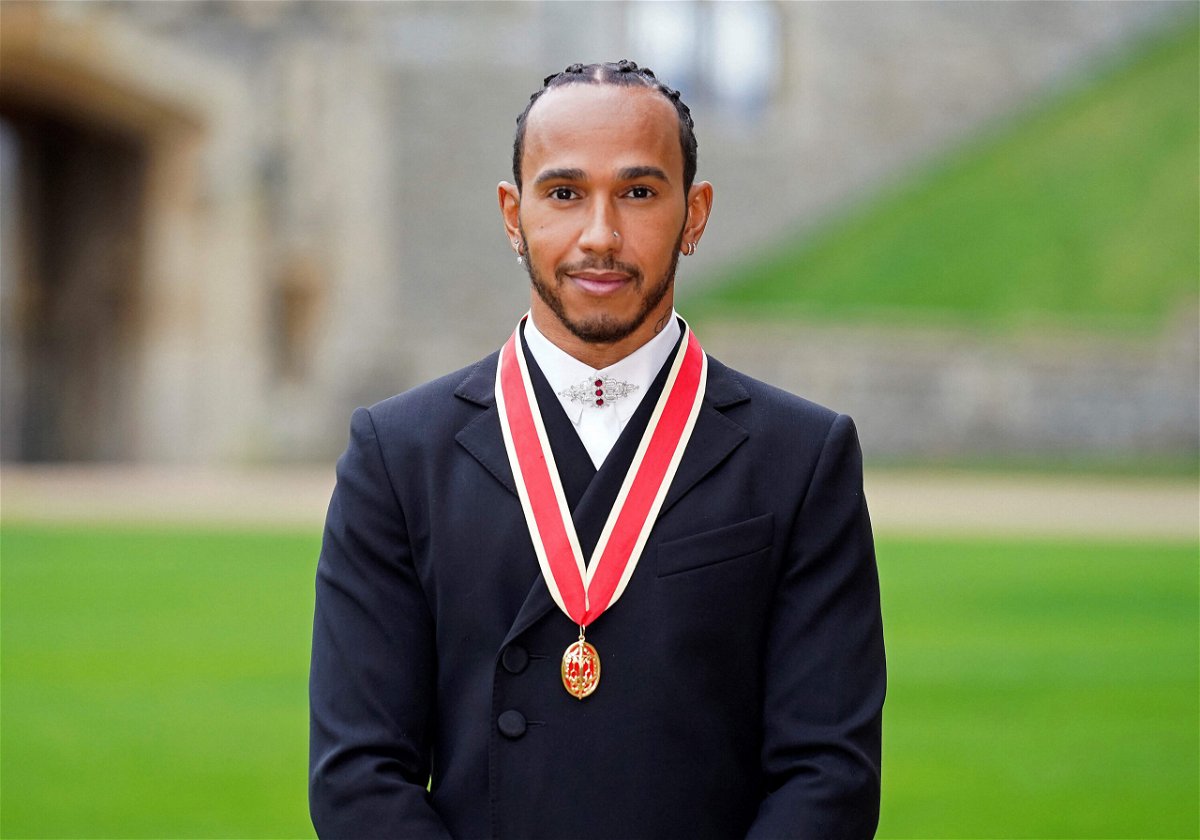 <i>Andrew Matthews/AFP/Getty Images</i><br/>Mercedes' British F1 driver Lewis Hamilton poses with his medal after being appointed as a Knight Bachelor for services to motorsports
