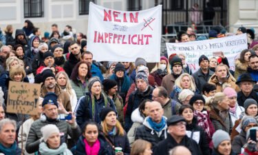 A demonstrator holds a placard reading 'No to compulsory vaccination' during an anti-vaccination protest at the Ballhausplatz in Vienna