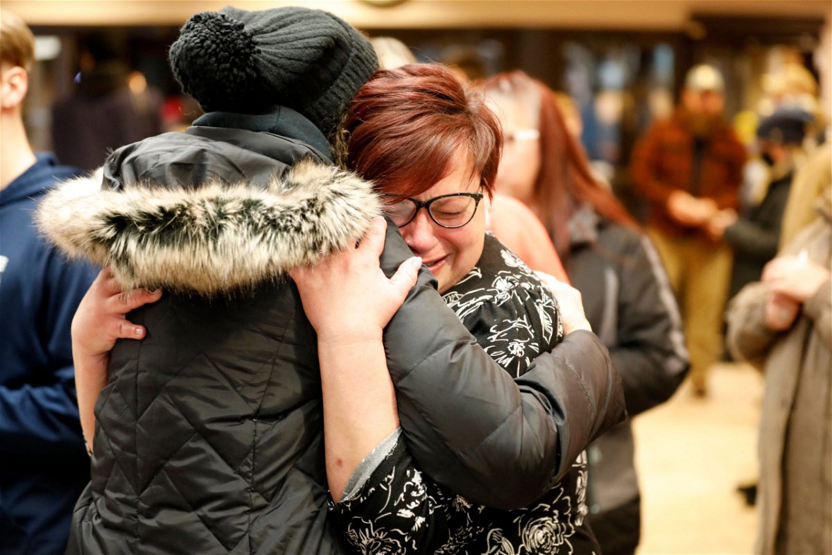 <i>Jeff Kowalsky/AFP/Getty Images</i><br/>People hug during a vigil following a shooting at Oxford High School at Lake Pointe Community Church in Lake Orion