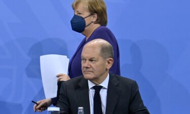 Acting Chancellor Angela Merkel and Olaf Scholz hold a press conference on Covid-19 restrictions