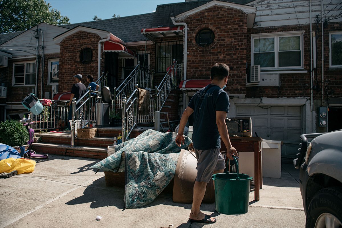 <i>Scott Heins/Getty Images</i><br/>Queens residents sort through damaged and destroyed items after the remnants of Hurricane Ida swept through New York City and flooded homes in September.