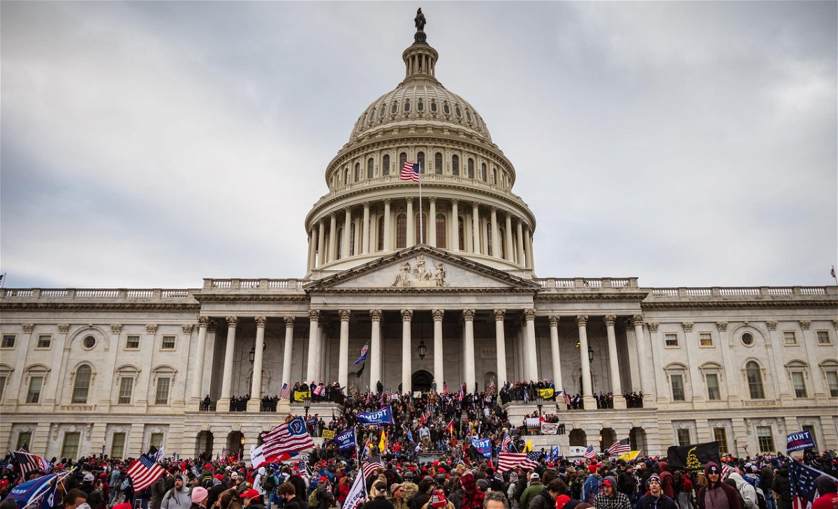 <i>Jon Cherry/Getty Images</i><br/>Democrats weigh how to talk about January 6 on the 2022 campaign trail as a large group of pro-Trump protesters stand on the East steps of the Capitol Building after storming its grounds on January 6