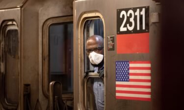 An MTA subway conductor wearing a KN95 face mask looks out of a window as the city continues Phase 4 of re-opening following restrictions imposed to slow the spread of coronavirus on August 9