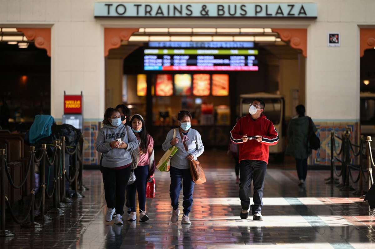 <i>Robyn Beck/AFP/Getty Images</i><br/>A family wearing face masks walks through Union Station in Los Angeles.