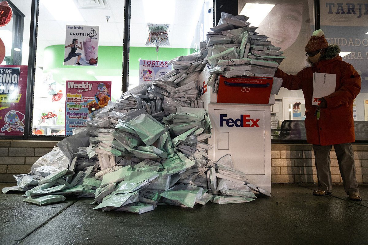 <i>E. Jason Wambsgans/Chicago Tribune/Tribune News Service/Getty Images</i><br/>At-home Covid-19 tests from Chicago Public  School students pile up at a FedEx drop-off box in the West Elsdon neighborhood of Chicago on December 28.