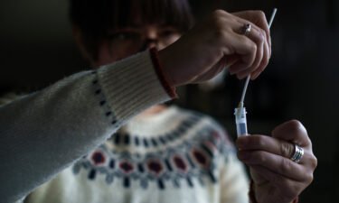 A New Hampshire resident processes a self-administered at-home Covid-19 test on December 7.