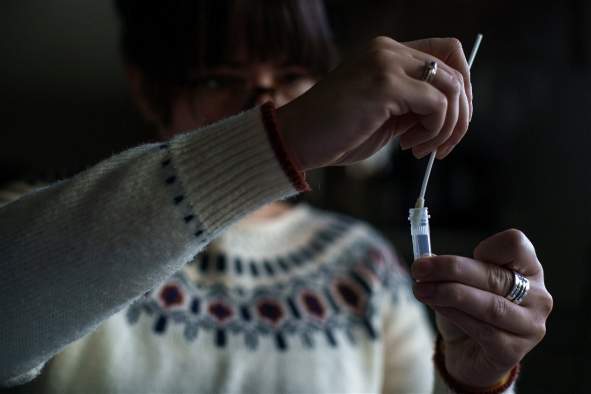 <i>John Tully/Bloomberg/Getty Images</i><br/>A New Hampshire resident processes a self-administered at-home Covid-19 test on December 7.