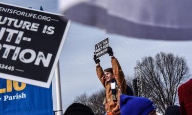 Demonstrators hold signs during the annual March For Life on the National Mall in Washington