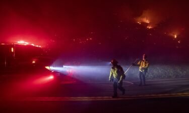 Firefighters battle the Colorado Fire burning along Highway 1 in Big Sur