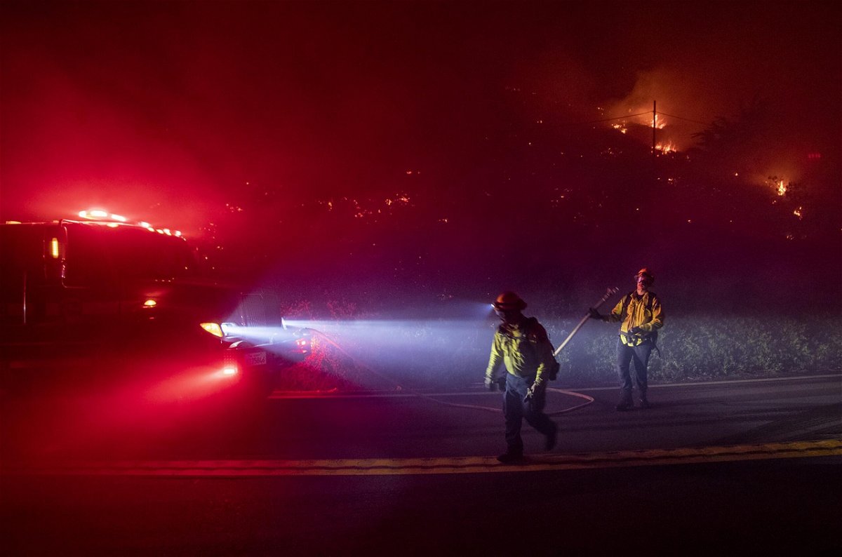 <i>Karl Mondon/MediaNews Group/The Mercury News/Getty Images</i><br/>Firefighters battle the Colorado Fire burning along Highway 1 in Big Sur