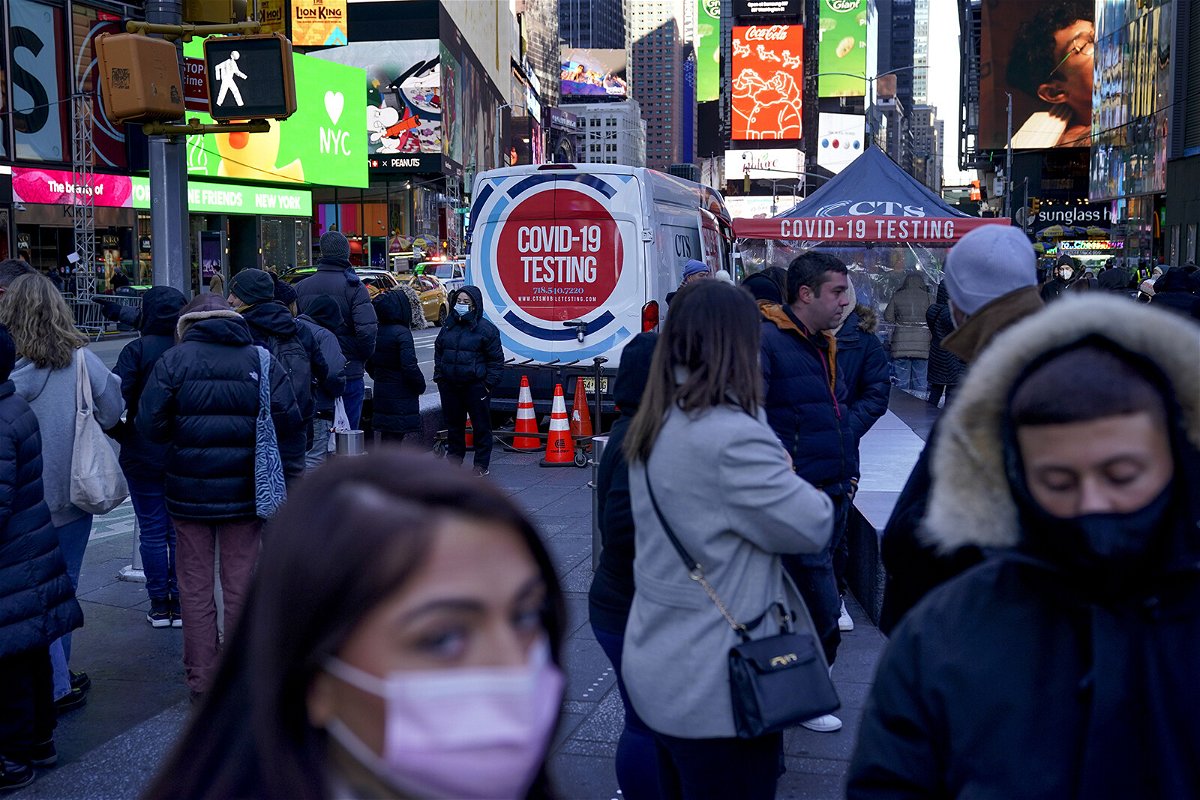 <i>Seth Wenig/AP</i><br/>People wait in a long line to get tested for Covid-19 in Times Square