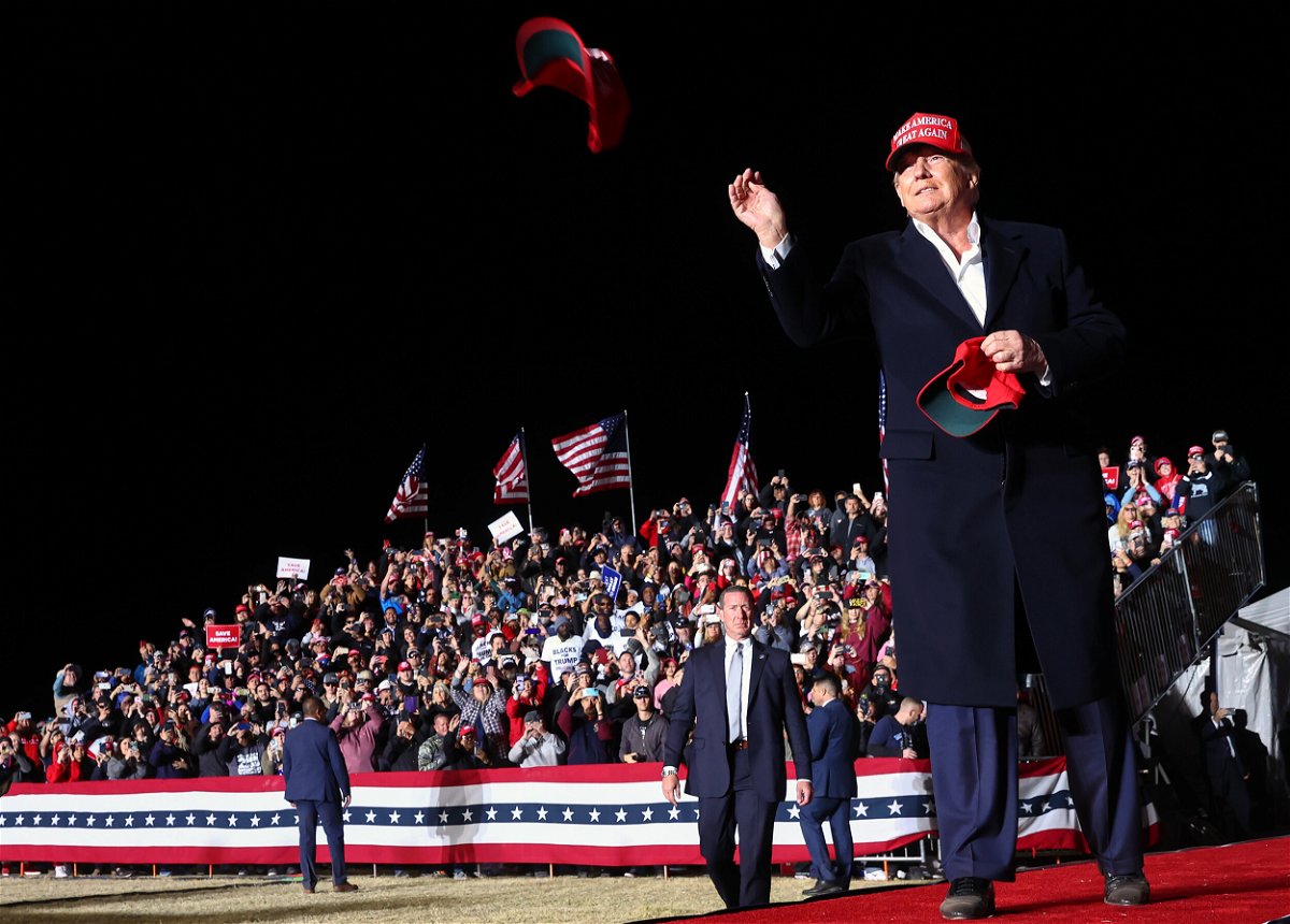 <i>Mario Tama/Getty Images</i><br/>Former President Donald Trump tosses a MAGA hat to the crowd before speaking at a rally at the Canyon Moon Ranch festival grounds on January 15