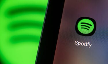 Spotify is making public platform rules that cover Covid-19 misinformation. Pictured is the Spotify app logo on the screen of a smartphone.