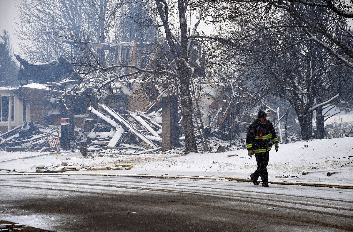 <i>Thomas Peipert/AP</i><br/>A destroyed home is covered in snow in Louisville