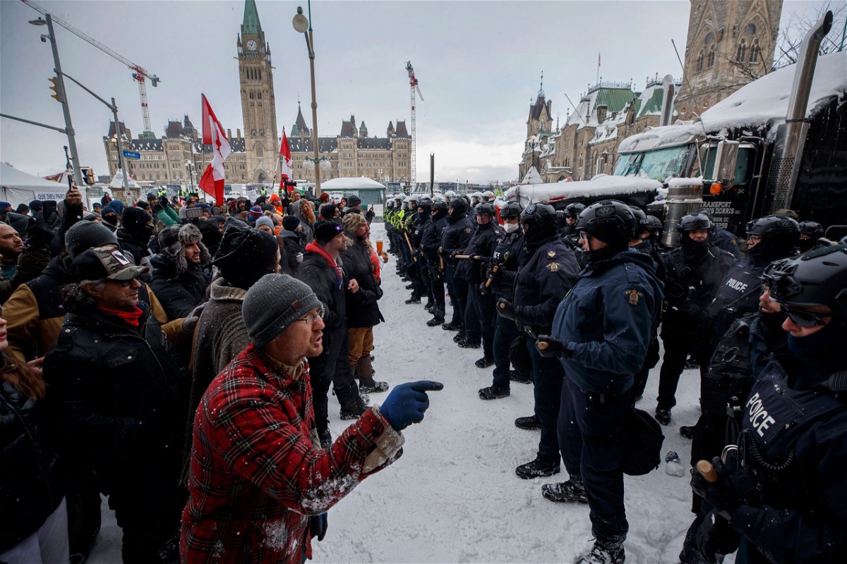 <i>Cole Burston/The Canadian Press/AP</i><br/>Police move in to clear protesters from downtown Ottawa near Parliament Hill on Saturday