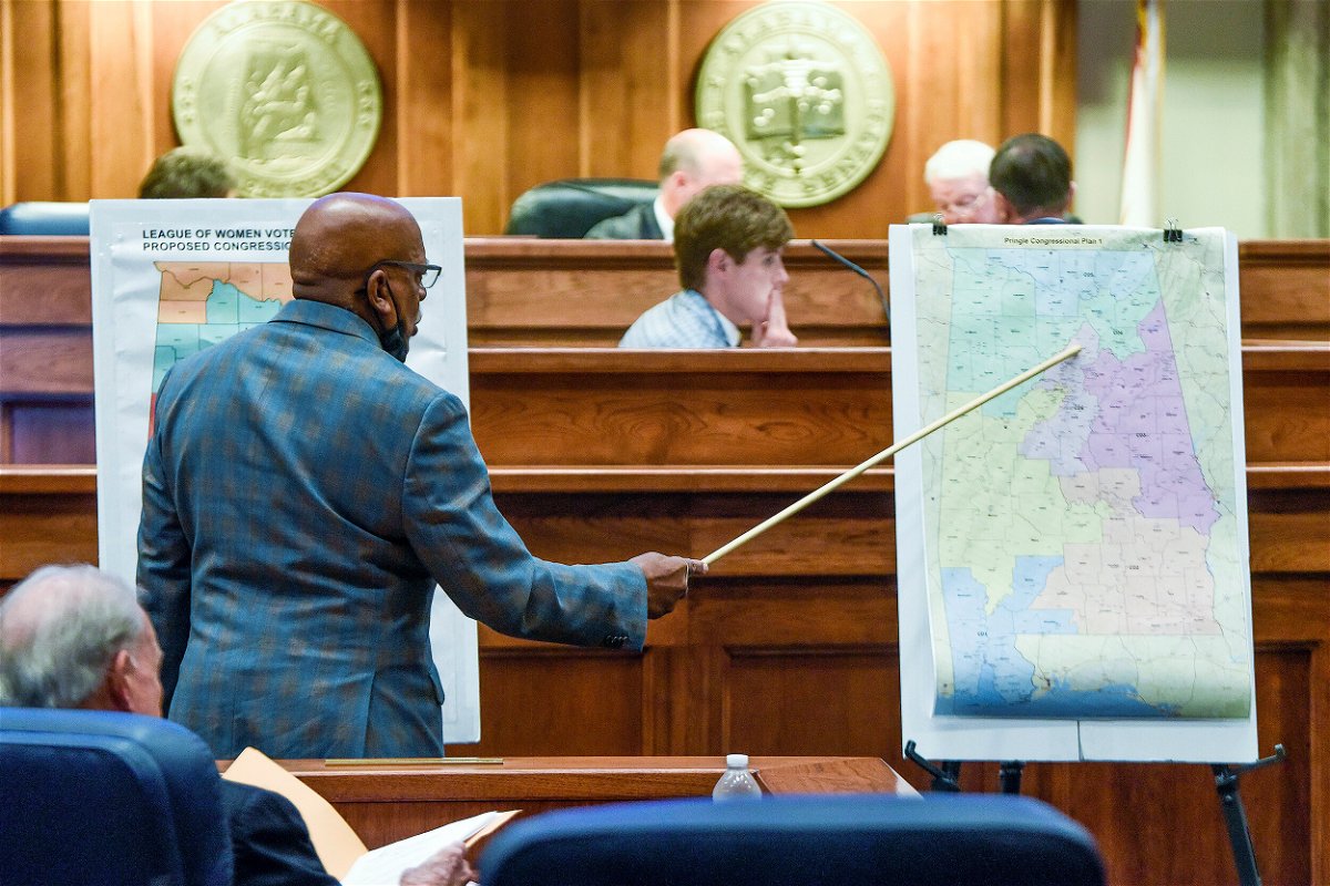 <i>Mickey Welsh/AP/FILE</i><br/>Sen. Rodger Smitherman compares U.S. Representative district maps during a special session on redistricting at the Alabama Statehouse in Montgomery
