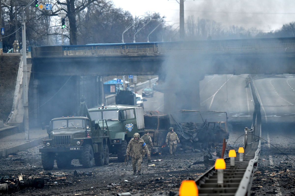<i>Sergei Supinsky/AFP/Getty Images</i><br/>Ukrainian service members are seen at the site of fighting with a Russian raiding group in Kyiv on the morning of February 26