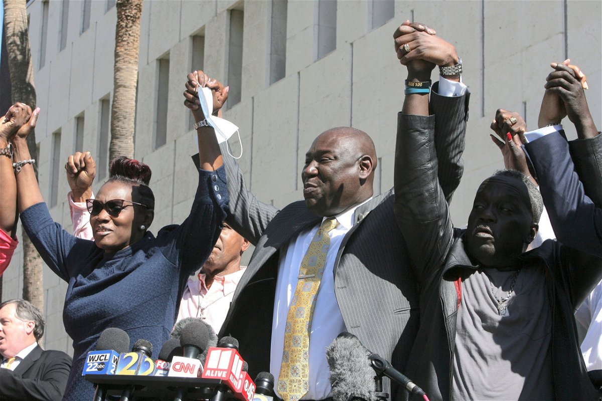 <i>Lewis Levine/AP</i><br/>Arbery family attorney Ben Crump (center) clasps hands with Arbery's mother