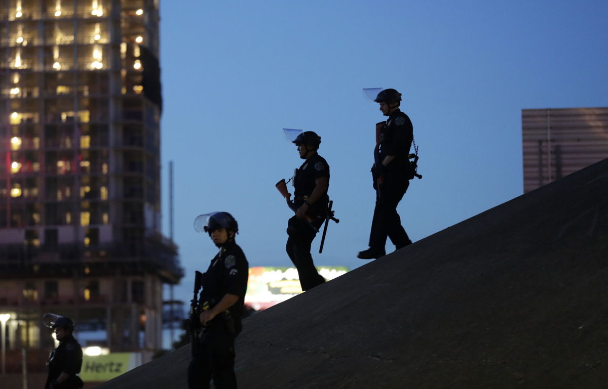<i>Eric Gay/AP</i><br/>Austin police keep watch as demonstrators gather on June 4