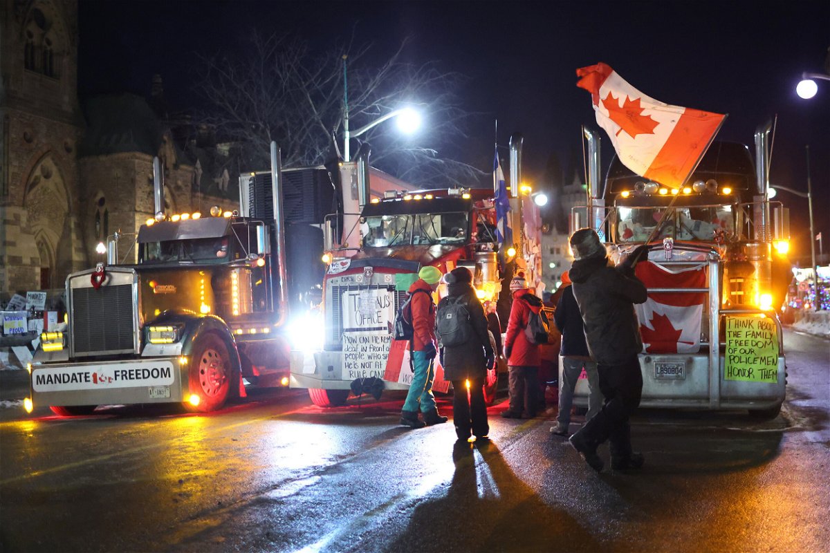 <i>Scott Olson/Getty Images</i><br/>Trucks and protesters block downtown streets near the Parliament Buildings as a demonstration continues on February 16 in Ottawa