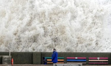 Waves crash into a sea wall in Liverpool