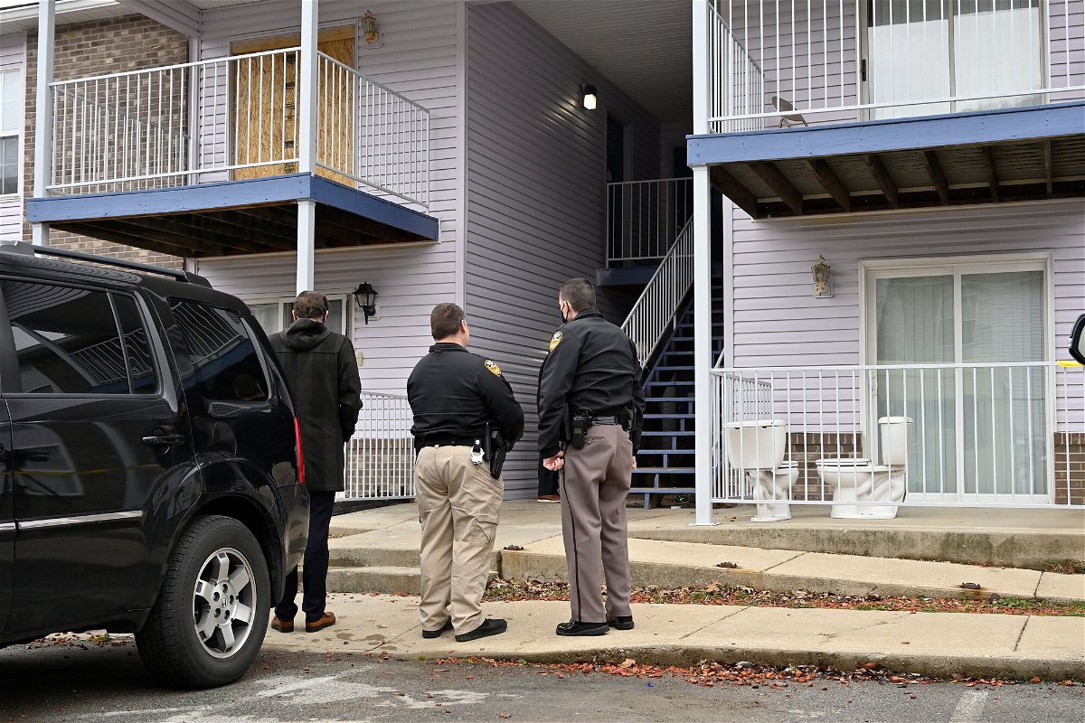 <i>Timothy D. Easley/Pool/AP</i><br/>Authorities stand guard as jurors are given a walk-through of Breonna Taylor's apartment in Louisville on February 25.