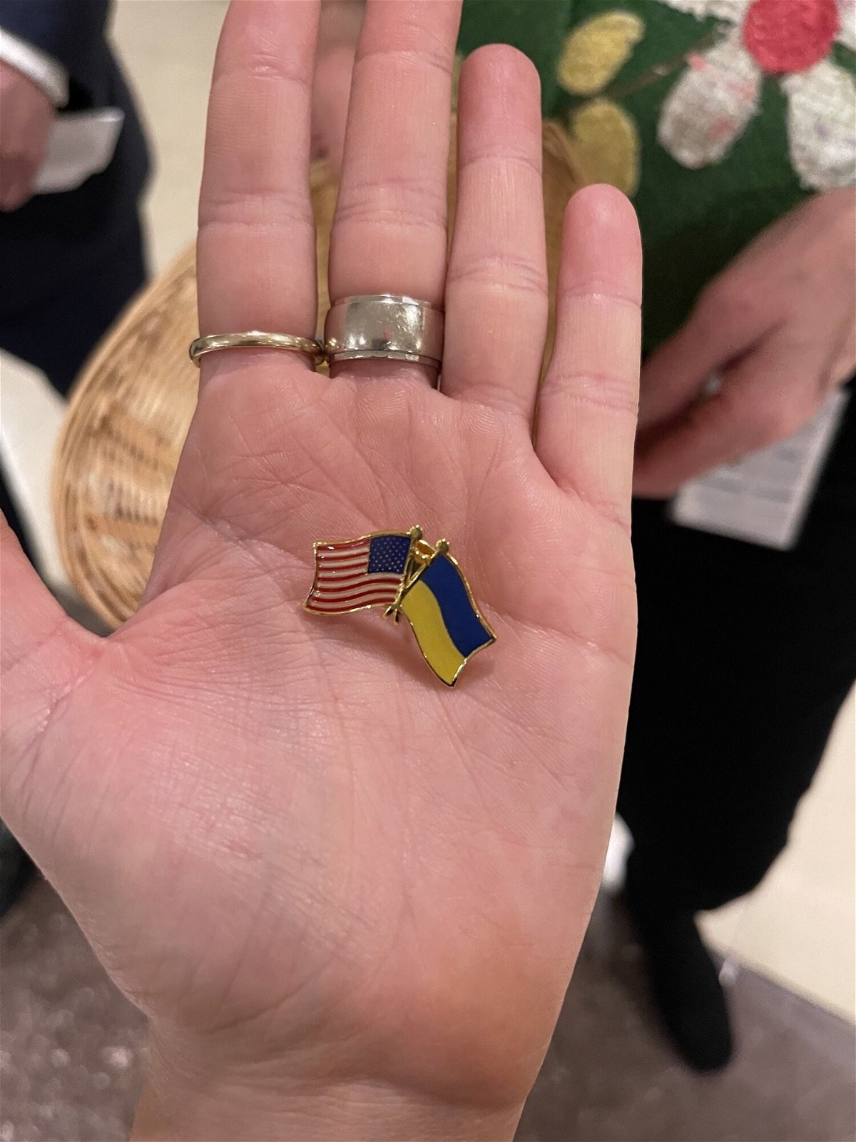 <i>Daniella Diaz/CNN</i><br/>Capitol staffer handed out Ukraine-US flag pins to lawmakers attending Zelensky's address at the Capitol on March 16.
