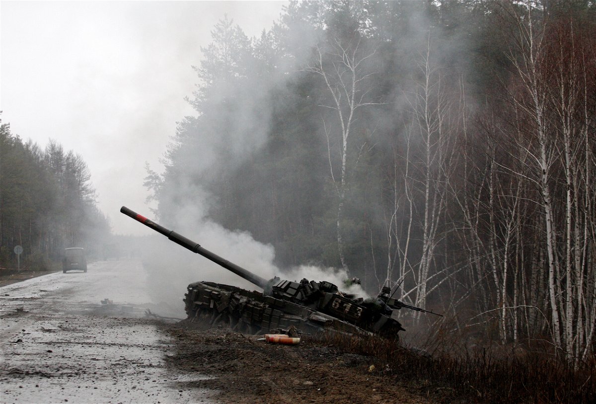 <i>Anatolii Stepanov/AFP/Getty Images/FILE</i><br/>Smoke rises from a Russian tank destroyed by the Ukrainian forces on the side of a road in Lugansk region on February 26.