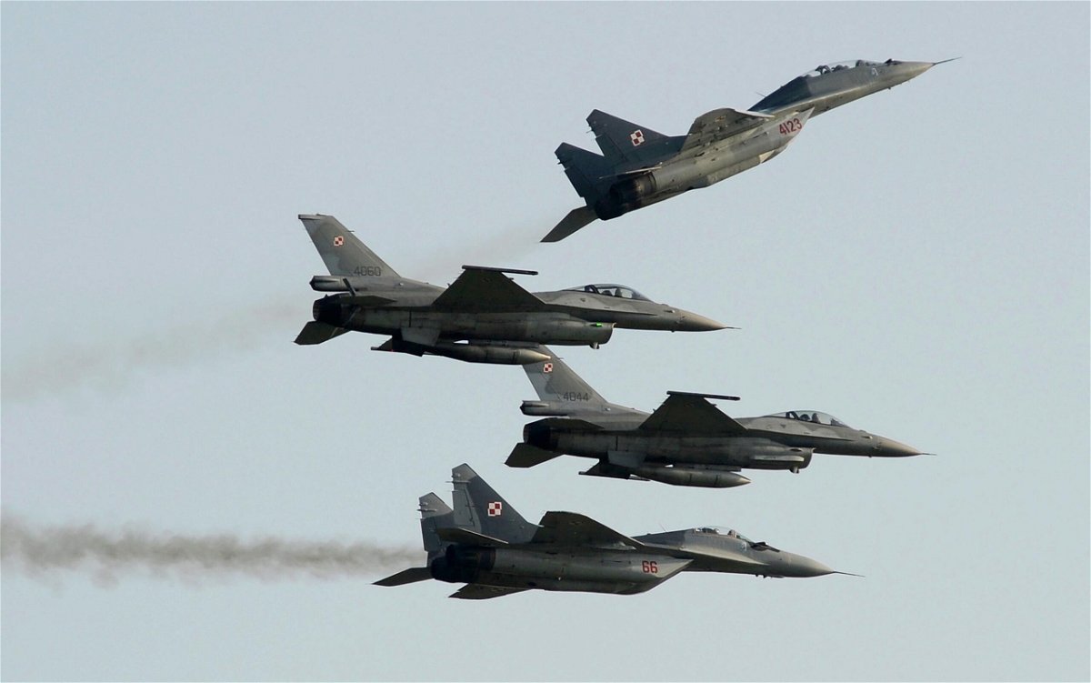 <i>Alik Keplicz/AP</i><br/>Two Polish Air Force Russian-made MiG-29's fly above and below two Polish Air Force US-made F-16's fighter jets during the Air Show in Radom