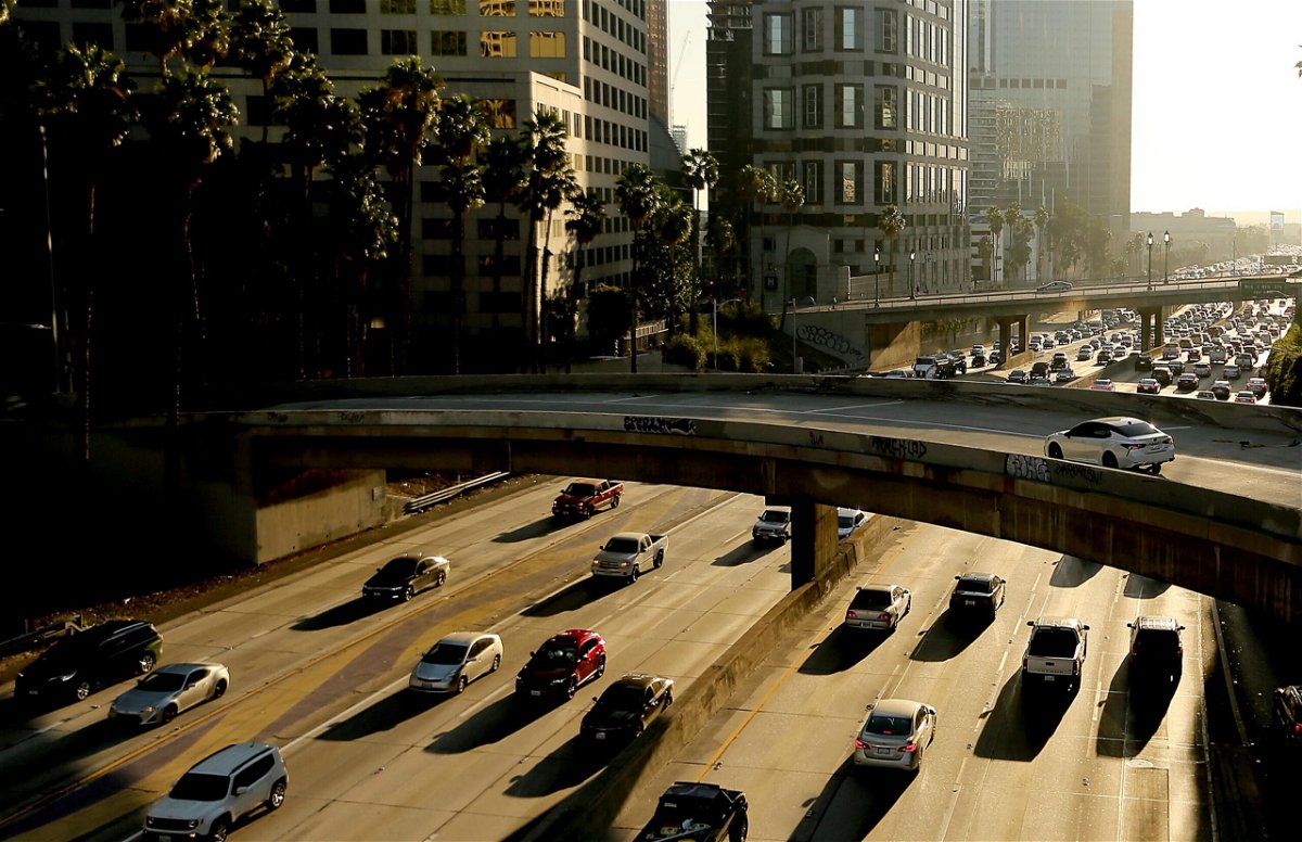 <i>Luis Sinco/Los Angeles Times/Getty Images</i><br/>Traffic slows on the Harbor Freeway in downtown Los Angeles in November 2021. The EPA announced Wednesday that it would allow California to adopt stricter vehicle emissions standards than the federal rules.
