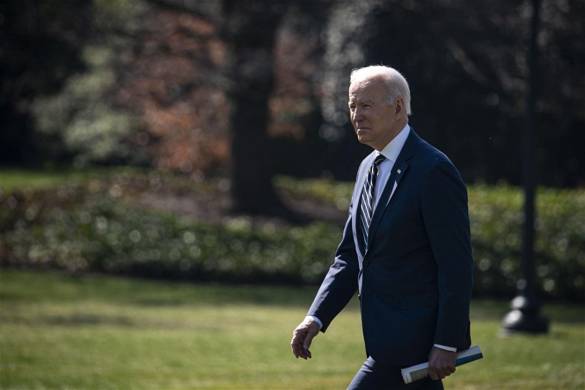 <i>Al Drago/Bloomberg/Getty Images</i><br/>President Joe Biden walks on the South Lawn of the White House before boarding Marine One on March 11. A group of 89 House Democrats
