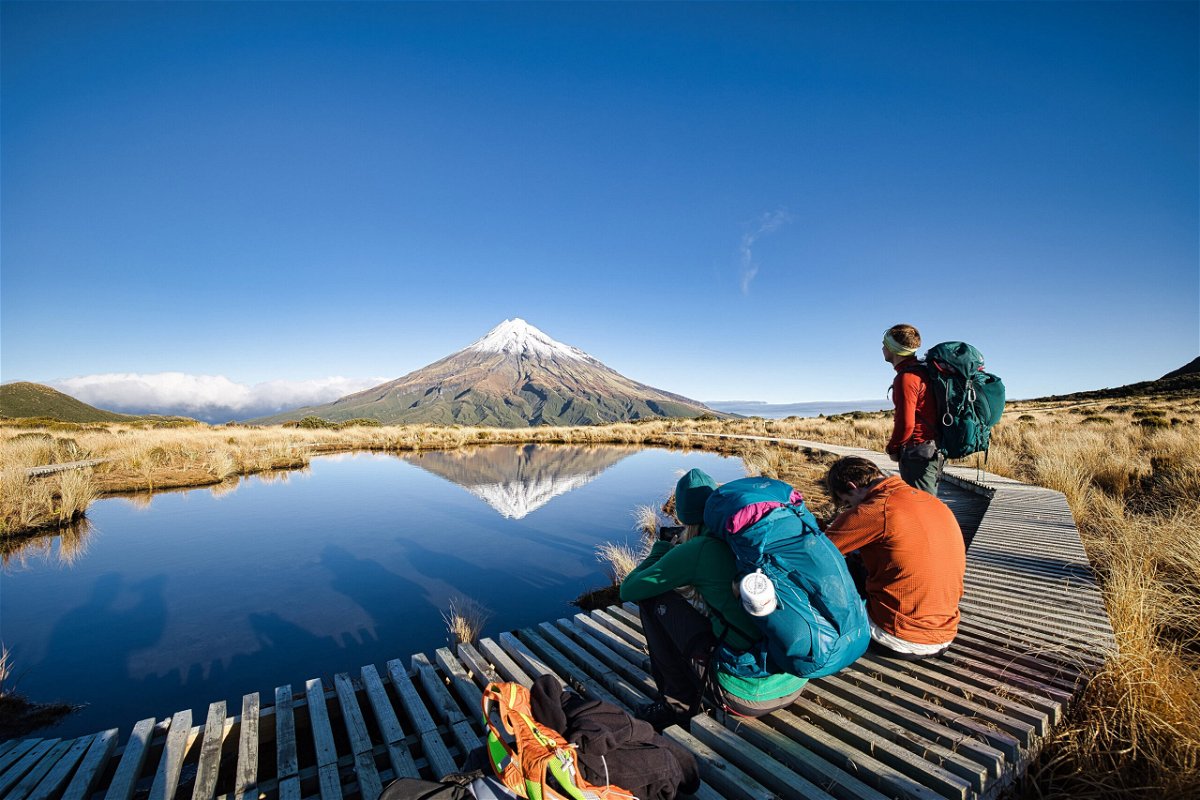 <i>Lu Huaiqian/Xinhua/Getty Images</i><br/>Tourists enjoy the view of Mount Taranaki in New Zealand