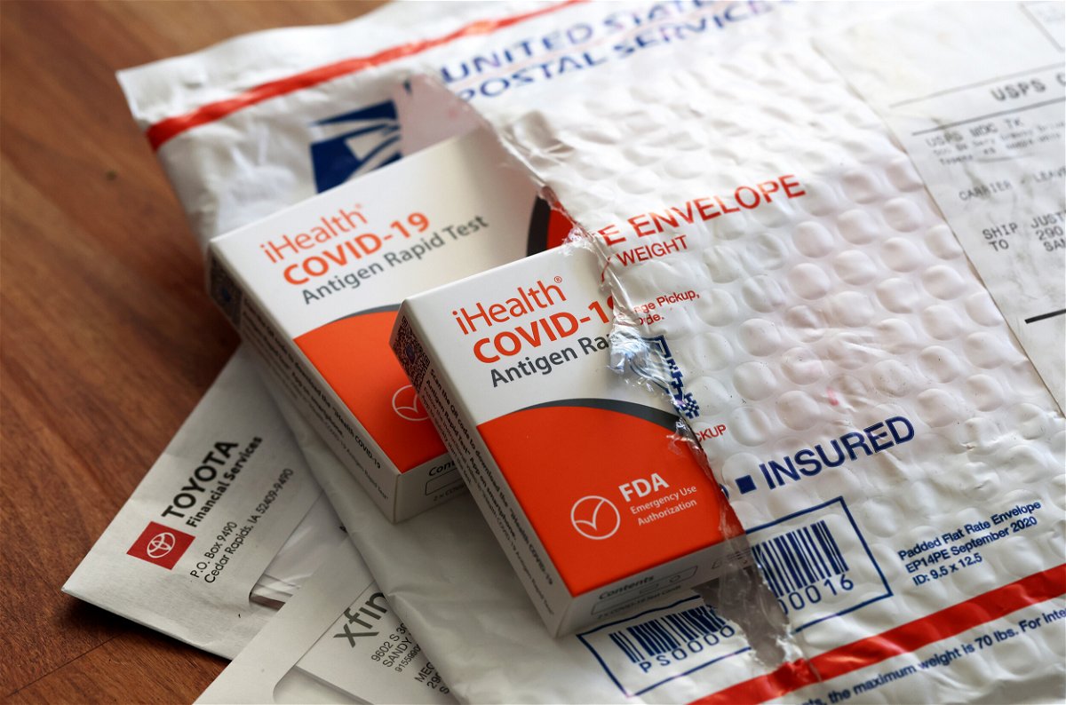 <i>Justin Sullivan/Getty Images</i><br/>Free iHealth COVID-19 antigen rapid tests from the federal government sit on a U.S. Postal Service envelope after being delivered on February 04
