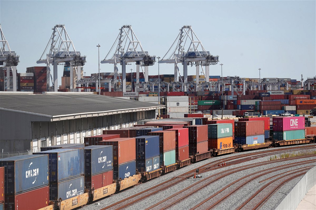 <i>OCTAVIO JONES/REUTERS</i><br/>A commercial freight train carries a load of shipping containers at the Port of Savannah in October. The Biden White House