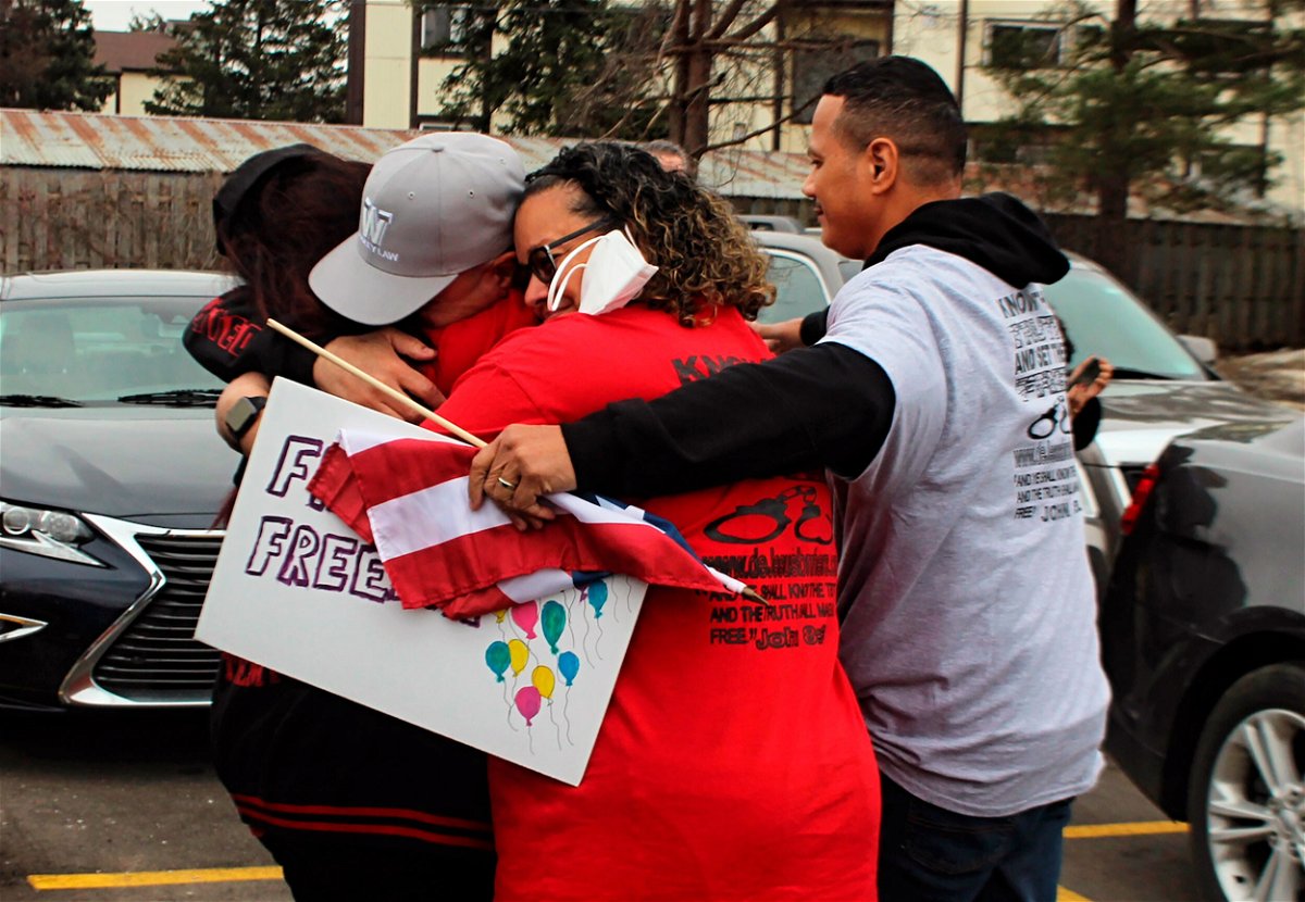 <i>Anna Liz Nichols/AP</i><br/>George DeJesus is embraced by family and supporters on March 22 at a restaurant in Lansing