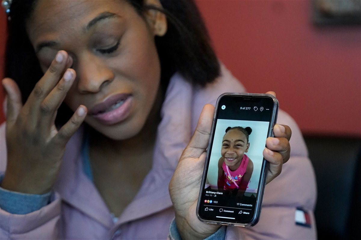 <i>Rick Bowmer/AP</i><br/>Brittany Tichenor-Cox holds a photo of her daughter