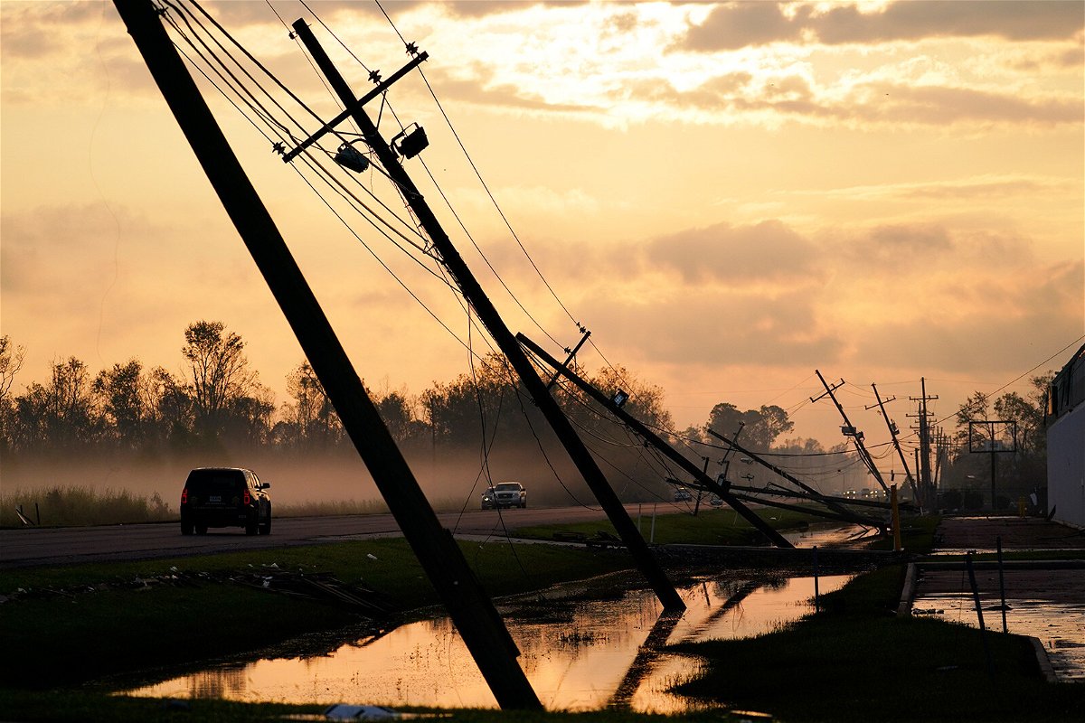 <i>Matt Slocum/AP</i><br/>Downed power lines slump over a road in the aftermath of Hurricane Ida in Reserve