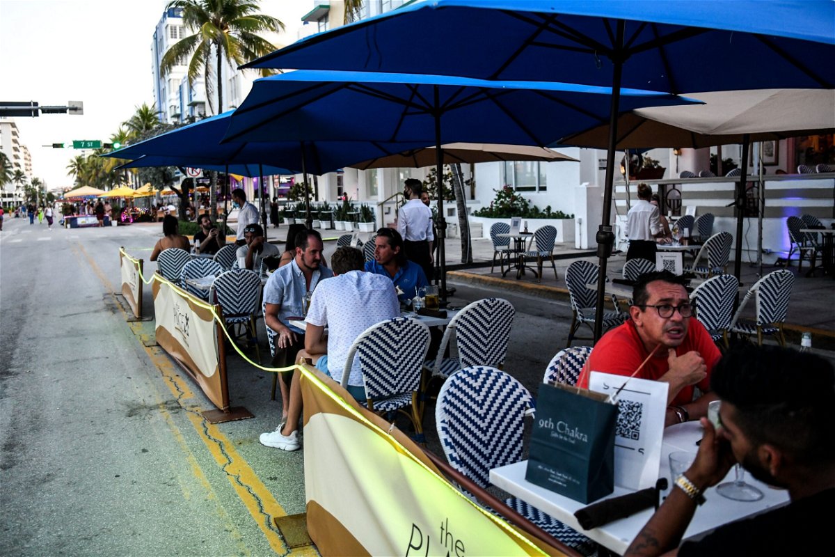 <i>Chandan Khanna/AFP/Getty Images</i><br/>People eat in the outdoor dining area of a restaurant on Ocean Drive in Miami Beach
