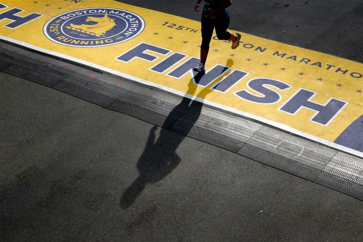 <i>Jessica Rinaldi/The Boston Globe/Getty Images</i><br/>A runner casts a shadow as she crosses the finish line of the 125th Boston Marathon in Boston in October. This year
