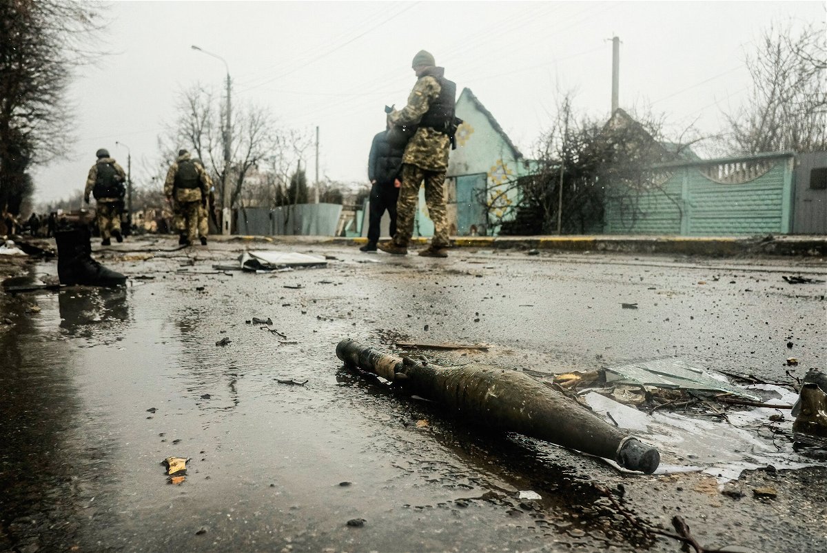 <i>Matthew Hatcher/SOPA Images/LightRocket/Getty Images</i><br/>Ukrainian soldiers inspect the wreckage of a destroyed Russian armored column on the road in Bucha