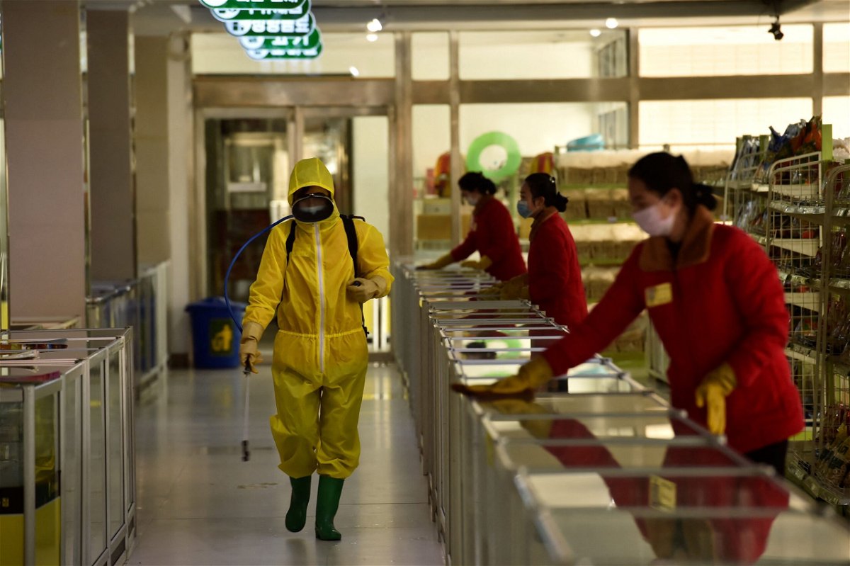 <i>Kim Won Jin/AFP/Getty Images</i><br/>Employees spray disinfectant and wipe surfaces as part of preventative measures against the Covid-19 coronavirus at the Pyongyang Children's Department Store in Pyongyang on March 18.