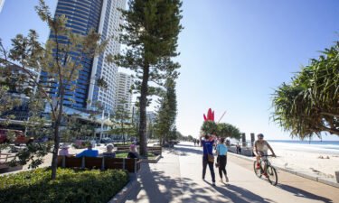 People walk along the Esplanade at Surfers Paradise in Gold Coast