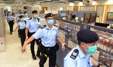 Police officers raid the Apple Daily headquarters in Hong Kong on August 10